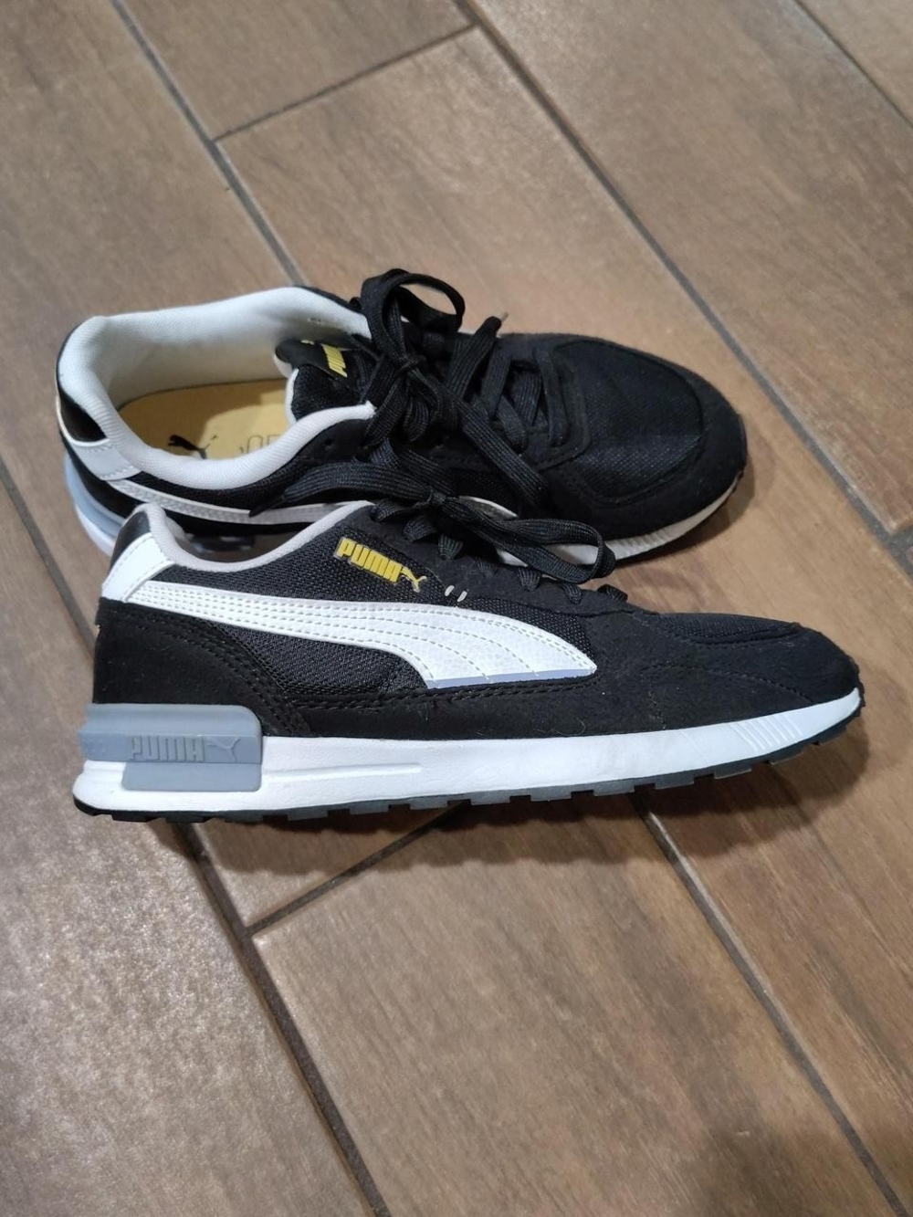 Puma Women's Black and White Low-Top Sneakers with Yellow Logo